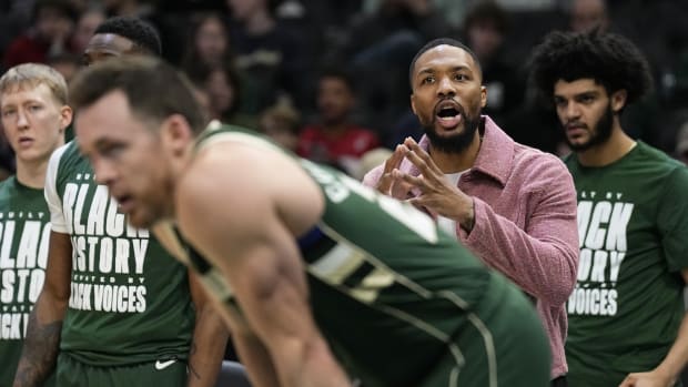 Milwaukee Bucks guard Damian Lillard calls out from the bench during the third quarter against the Minnesota Timberwolves 